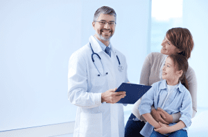 happy-doctor-holding-clipboard-with-patients smiling and standing in Absolute urgent care clinic
