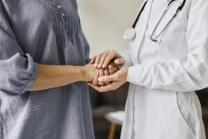 primary care-female-doctor-holding-older-patient-s-hands
