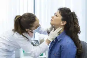 endocrinologist-examining-throat-young-woman-clinic-women-with-thyroid-gland-test-endocrinology-hormones-treatment-inflammation-sore-throat-scaled