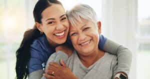 Primary Care Provider hugging her patient and smiling
