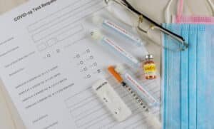 a image of COVID-19 Testing & Treatment test tubes and needles