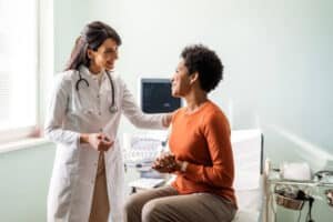 Primary Care provider talking to a patient in Urgent Care facility