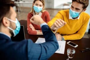 A health professional giving health advice about travel vaccination to a male and female patient
