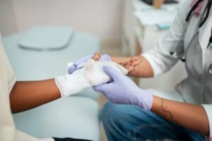 A male doctor giving treatment to a minor burn condition of a patient